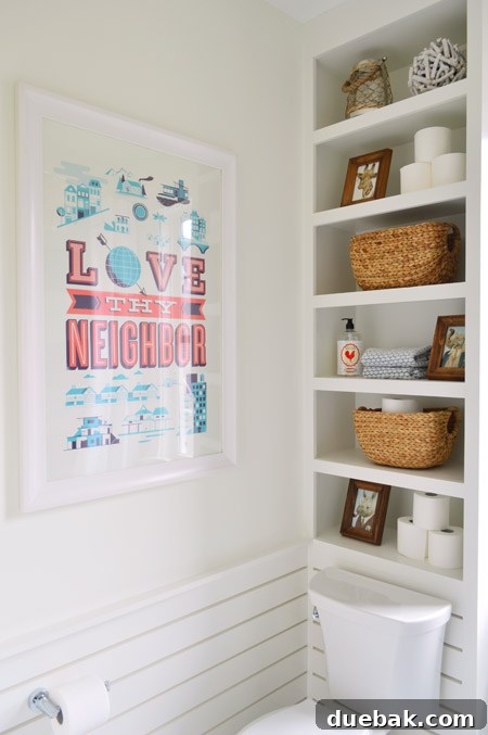 The Family Act 13 Bathroom with a shelf above the toilet and slatted wainscoting