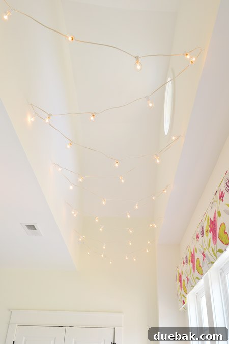 The Family Act 20 String lights installed in a vaulted ceiling above a desk