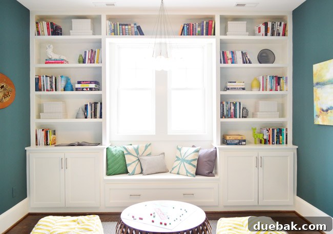 The Family Act 25 Playroom with blue-green walls, white built-ins, and various art pieces