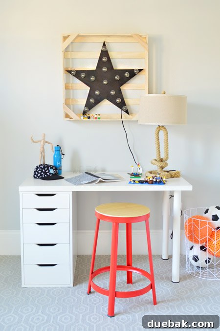 The Family Act 5 Detailed shot of a desk area with an orange stool and creative decor