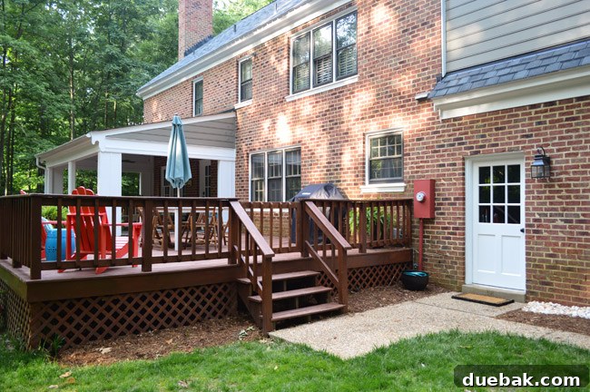 View Of Brick House Backyard With Refreshed Garage Door Area