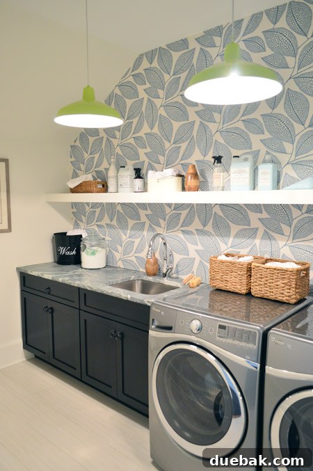 Our Showhouse: Full Video Walkthrough 13 Laundry room with Pebble Leaf wallpaper, lime green pendants, and wood cabinets