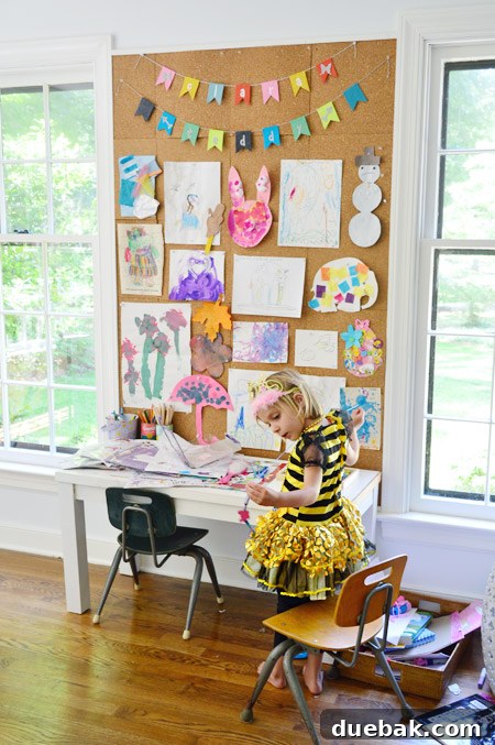 Little girl playing at her desk next to the organized office shelves