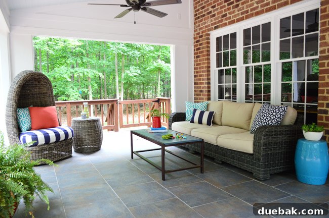 A woman tenderly holding a baby, gently rocking in the swivel wicker egg chair on the porch, enjoying family time