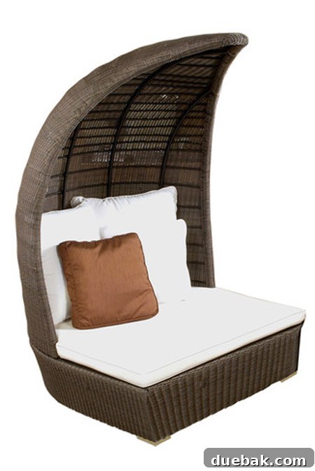 A large, luxurious boat-like woven outdoor lounge chair with white cushions, appearing incredibly cozy but too big for the space