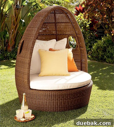 A Pottery Barn style woven egg chair with a warm brown hue and solid base, a close but not exact match to the ideal chair