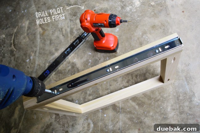 Step-by-step process of attaching the drawer rail part of the slide to the custom wooden frame.