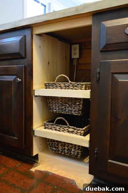Both slide-out basket drawers installed within the cabinet, showcasing the new storage system.