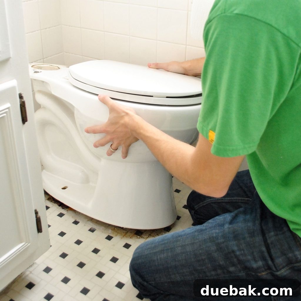 John Rocking Old Toilet Bowl To Loosen Wax Ring