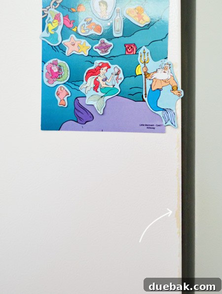 White painted refrigerator with magnets