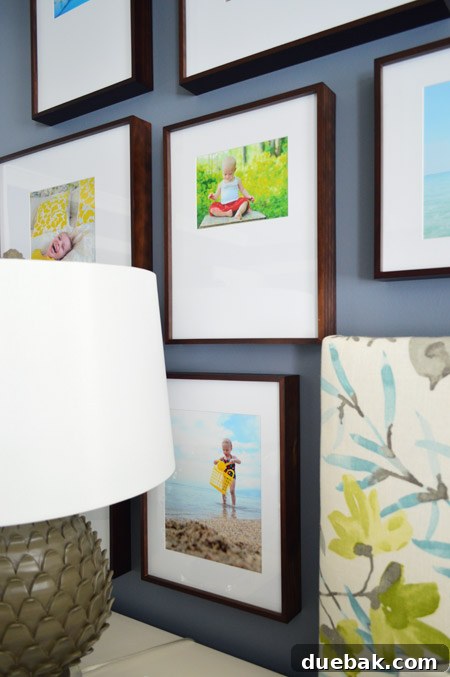 Full view of the transformed master bedroom with the family photo gallery wall