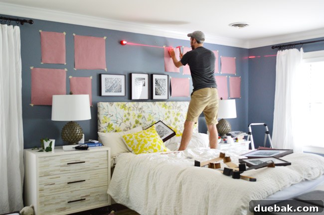 Hanging frames on the wall with tools like a laser level