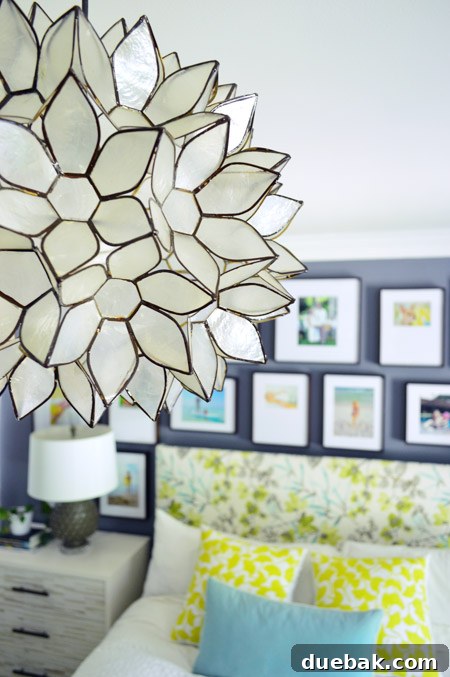 Elegant capiz chandelier illuminates a modern bedroom