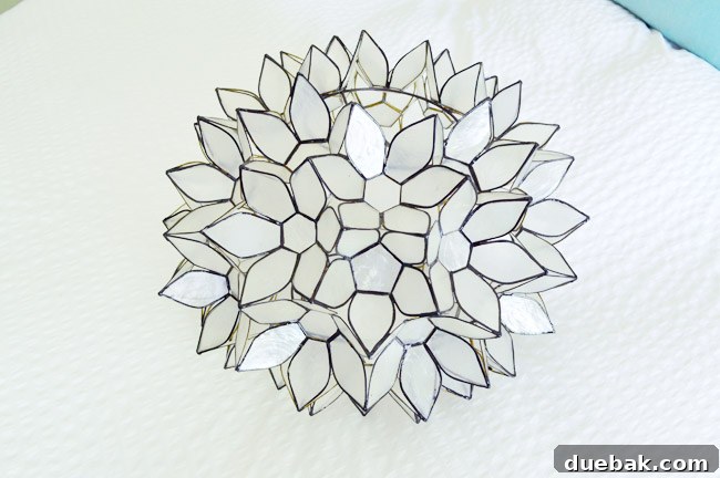 Capiz lotus pendant light disassembled on a table