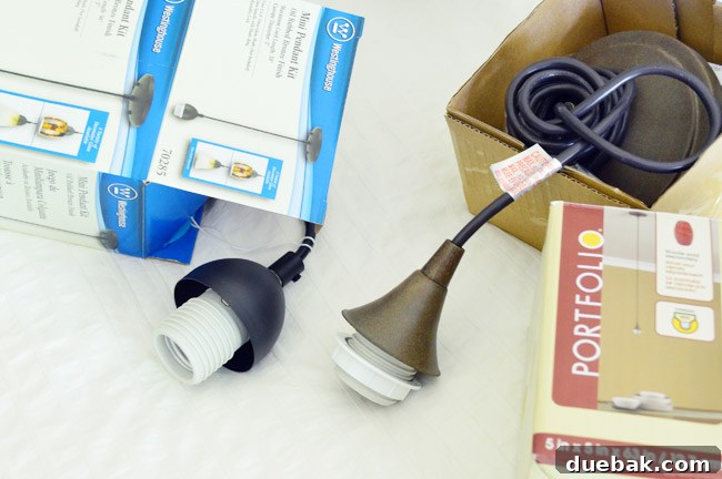 Two bronze light kits side by side from Home Depot and Lowe's