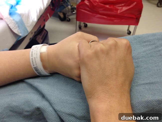 A doctor's gloved hands during the C-section, a moment before Teddy's arrival.