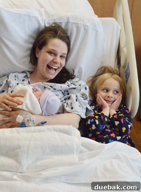 Clara gently interacting with her newborn brother Teddy, a heartwarming sibling introduction.