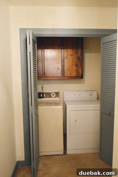 Our Laundry Room Transformation Begins 3 Laundry room after initial updates, with new flooring and appliances, without bi-fold doors