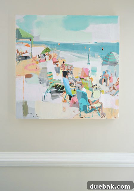 Close-up of Teil Duncan beach painting, showcasing colorful umbrellas, chairs, and figures on a sandy beach.