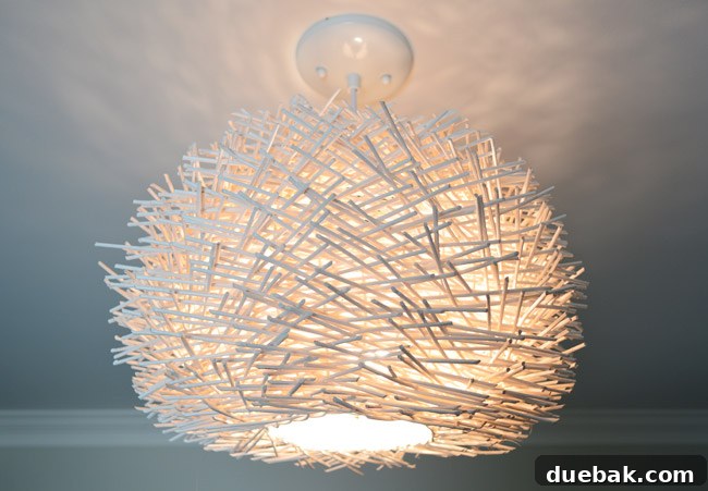 Upcycle Your Lamp into a Stunning Pendant Light 14 Teddy's room ceiling light fully lit, casting a warm glow
