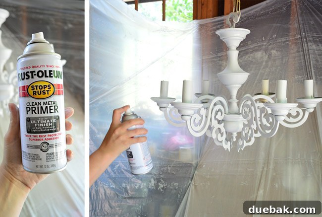 Chandelier after application of clean metal primer, showing its new white base coat and taped electrical sockets.