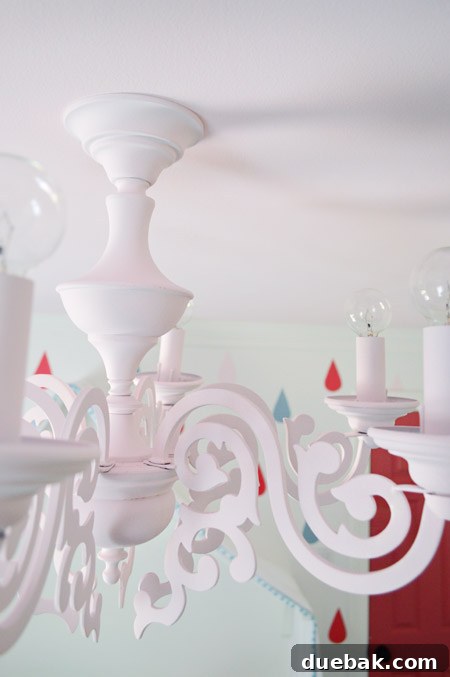 The shortened pink chandelier newly installed in Clara's room, showing its perfect height from the ceiling.