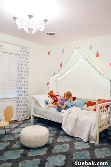 Clara's room at night with the repurposed pink chandelier and fairy lights creating a magical, ambient glow.