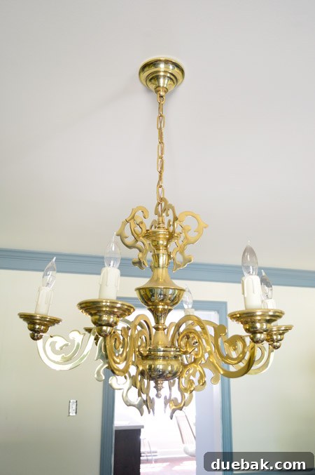 The original ornate chandelier hanging in the dining room before its complete makeover and repurposing.
