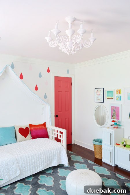Clara's custom pink chandelier, beautifully installed and serving as a whimsical focal point in her room.