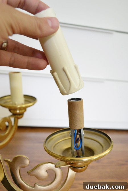 Close-up of chandelier candle sleeves, showing one flipped upside down to hide faux wax drips for a cleaner look.
