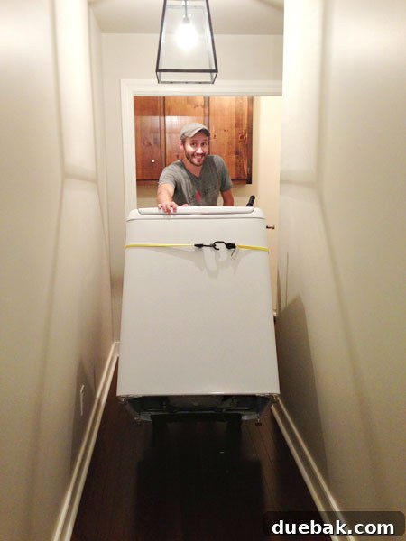 Starting Our Laundry Room Transformation 2 Washing machine temporarily placed in a bedroom during a home renovation project, highlighting the creative solutions for living through a remodel.