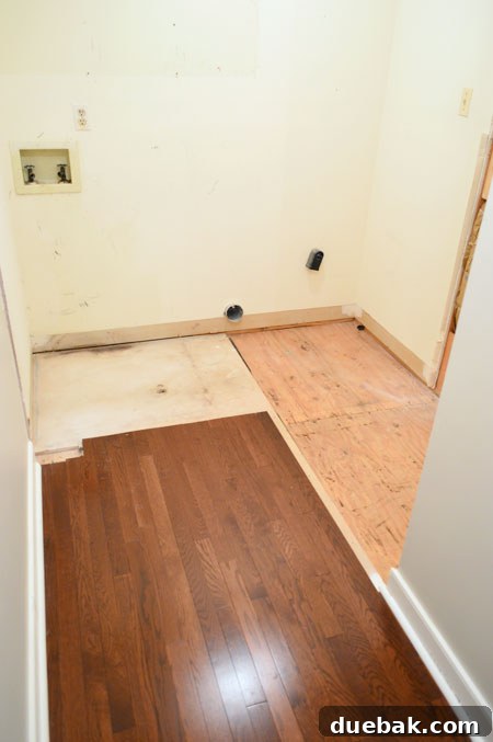 The Ultimate Laundry Room Makeover: From Demolition to Design 12 Plywood subfloor exposed, ready for new wall framing
