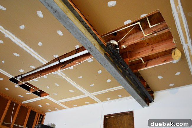 The Ultimate Laundry Room Makeover: From Demolition to Design 18 Plumbing lines relocated through the garage ceiling