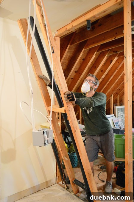 The Ultimate Laundry Room Makeover: From Demolition to Design 25 Removing old plumbing pipes with a reciprocating saw