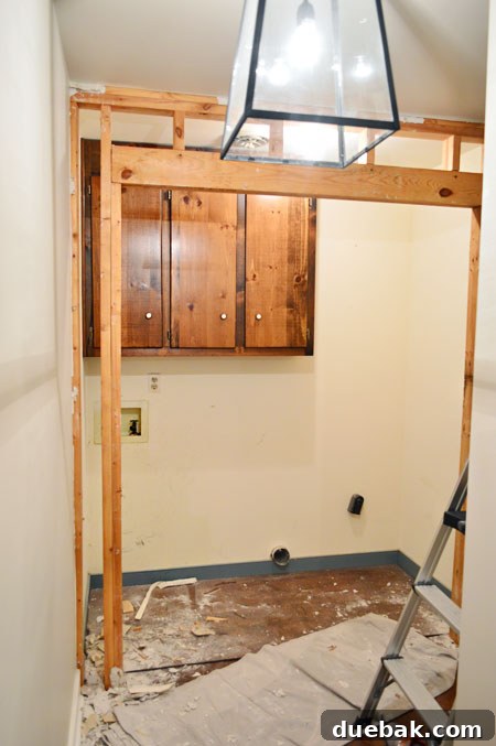 The Ultimate Laundry Room Makeover: From Demolition to Design 7 Removing old cased opening framing, highlighting the effort involved