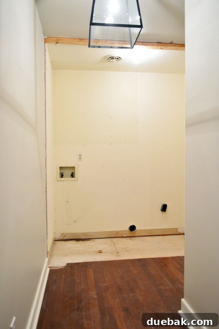 The Ultimate Laundry Room Makeover: From Demolition to Design 9 Upper cabinet removed, space is now completely empty for renovation