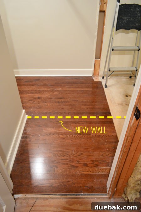 The Ultimate Laundry Room Makeover: From Demolition to Design 10 Removing hardwood flooring to prepare for new wall framing