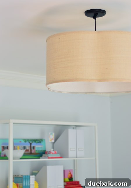 Elegant overhead light fixture installed in a home office, featuring a quatrefoil design and a mix of traditional and modern styles.
