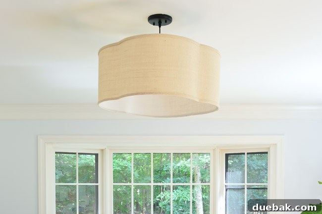 Close-up of the elegant overhead light fixture with a traditional design, casting a warm glow in the office.