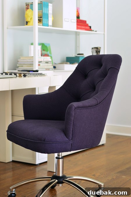 A new navy blue desk chair with button tufting and a sleek design, ready for a comfortable workspace.