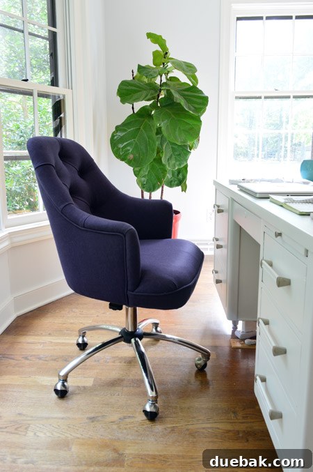 Close-up of the textured navy blue fabric of the new office chair, showcasing its quality and design.
