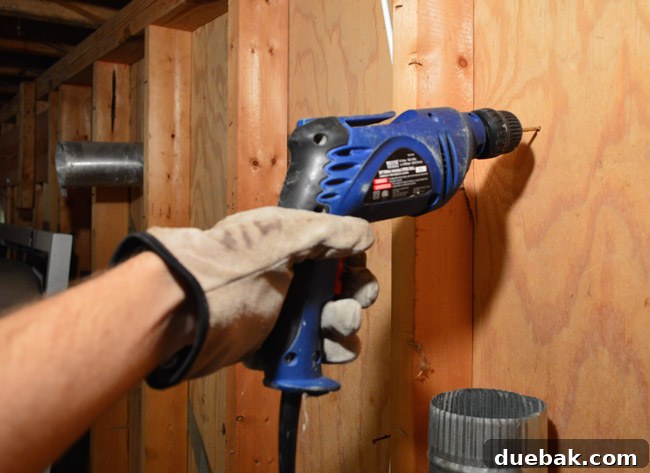 Routing New Laundry Exhaust Systems 13 Drilling a pilot hole from inside the room to accurately mark the new exterior dryer vent location for perfect alignment