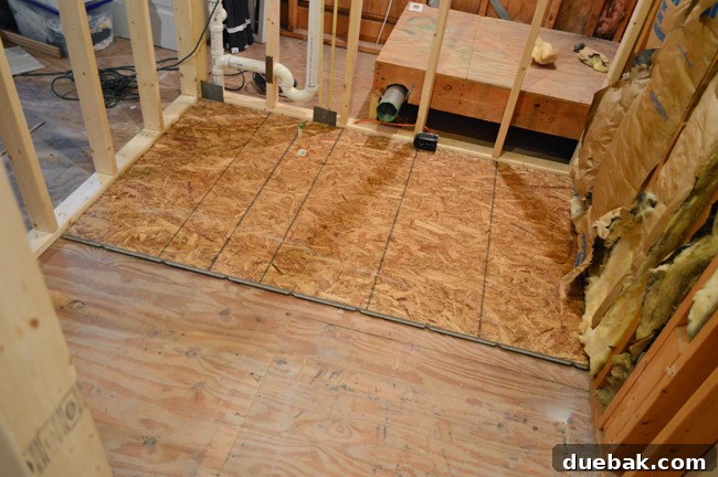 Routing New Laundry Exhaust Systems 23 Installing the first sheet of 1/2-inch OSB subfloor, glued and screwed down, in the laundry room for a solid base