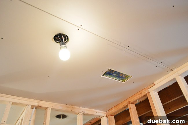 Routing New Laundry Exhaust Systems 35 Partially drywalled laundry room, showing significant progress after vent and subfloor work is complete