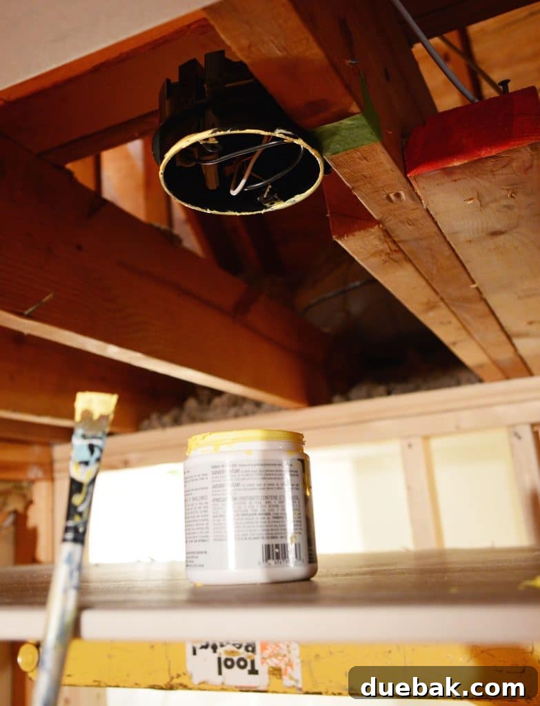 light fixture box in ceiling marked with yellow paint