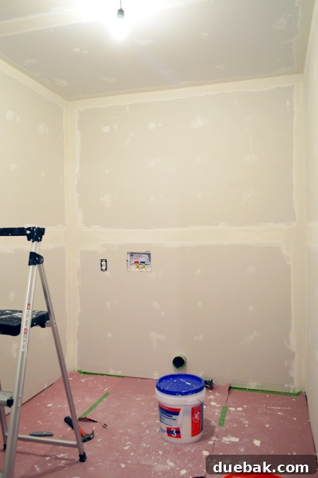 small room with one coat of drywall tape and mud applied