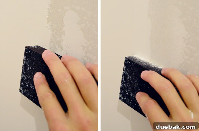 rubbing wet sanding block on drywall mud to smooth