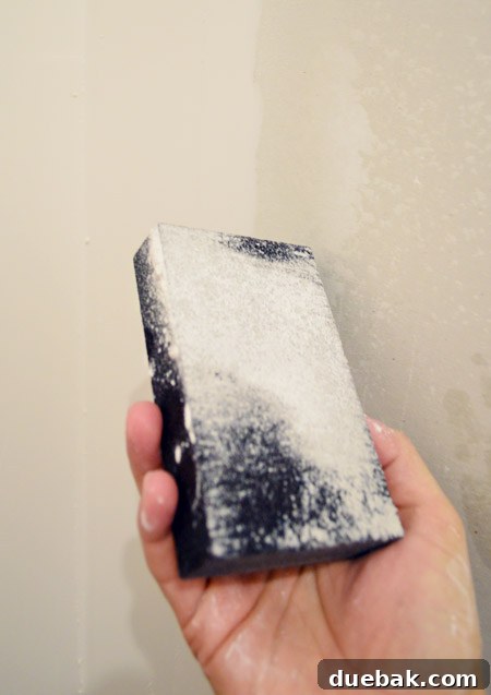 wet sanding block with wet dust coating it after drywall sanding