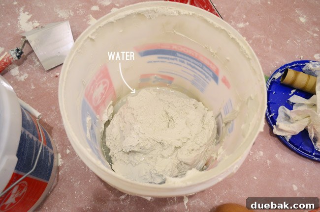 bucket of joint compound with a little bit of water in it to thin it out