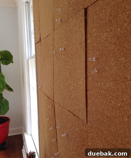 Cork bulletin board with falling squares before repair